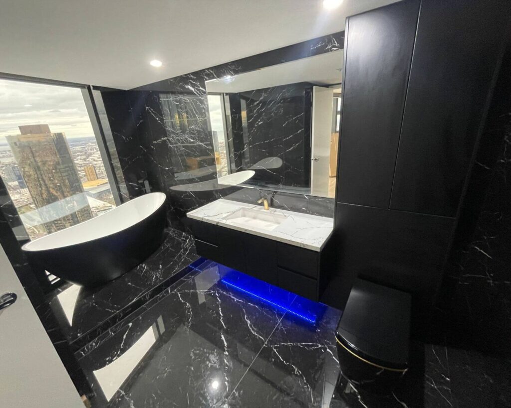 black luxury bathroom with tub - renovation builders melbourne