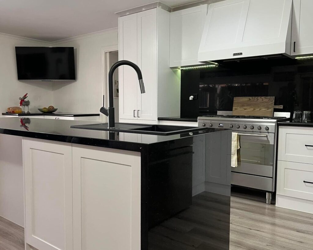 kitchen white cabinets black countertops - renovation builders melbourne